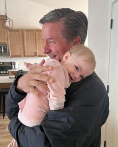 Alan of Caplin Custom Homes holds his granddaughter
